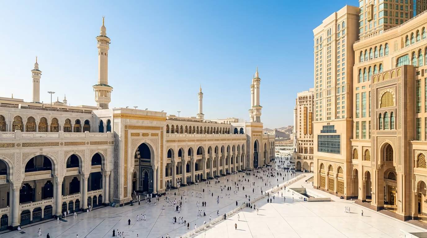 The Masjid al-Haram in Makkah in daylight, with pilgrims in the courtyard